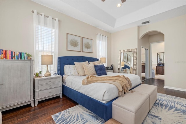 6907 47th Ct E, Ellenton, FL 34222 - bedroom with multiple windows, wood finished floors, arched walkways, a raised ceiling, and recessed lighting
