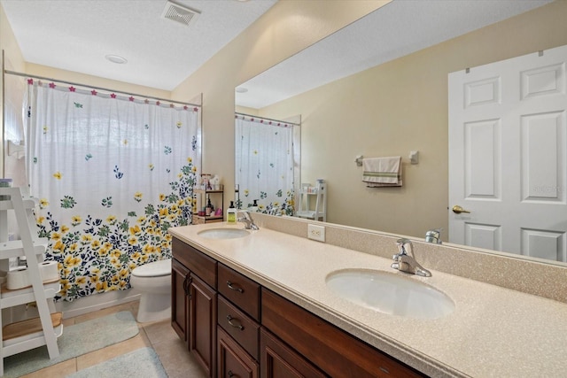 6907 47th Ct E, Ellenton, FL 34222 - bathroom featuring double vanity, toilet, and tile patterned flooring