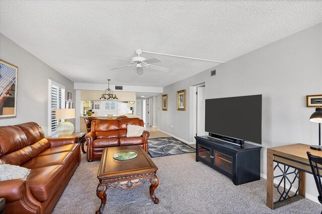 6480 Midnight Pass Rd Unit 311, Sarasota, FL 34242 - carpeted living area with a ceiling fan, a textured ceiling, a chandelier, and baseboards
