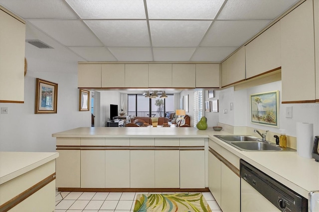 6480 Midnight Pass Rd Unit 311, Sarasota, FL 34242 - kitchen with white dishwasher, cream cabinets, a drop ceiling, a sink, and light countertops
