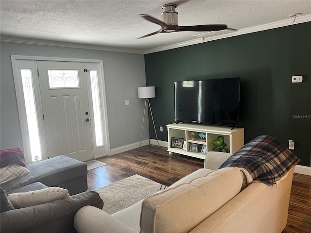 living room with a textured ceiling, wood finished floors, crown molding, ceiling fan, and baseboards