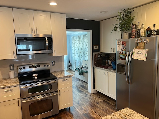 kitchen featuring appliances with stainless steel finishes, dark wood-style floors, white cabinetry, and recessed lighting
