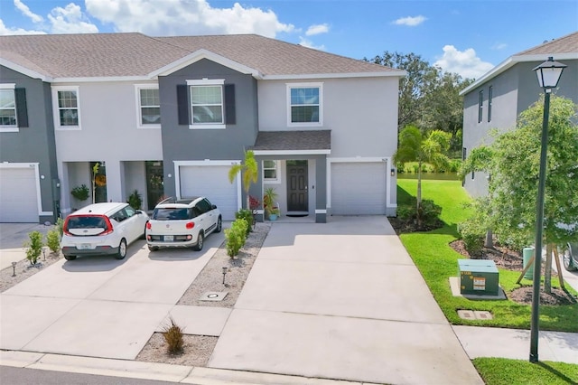 8628 Milestone Dr, Sarasota, FL 34238 - view of front of property with concrete driveway, a shingled roof, stucco siding, and a garage