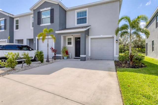 8628 Milestone Dr, Sarasota, FL 34238 - view of front of property with an attached garage, stucco siding, concrete driveway, and a front lawn