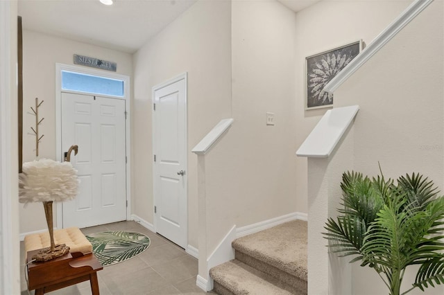 8628 Milestone Dr, Sarasota, FL 34238 - foyer with tile patterned flooring, stairway, and baseboards