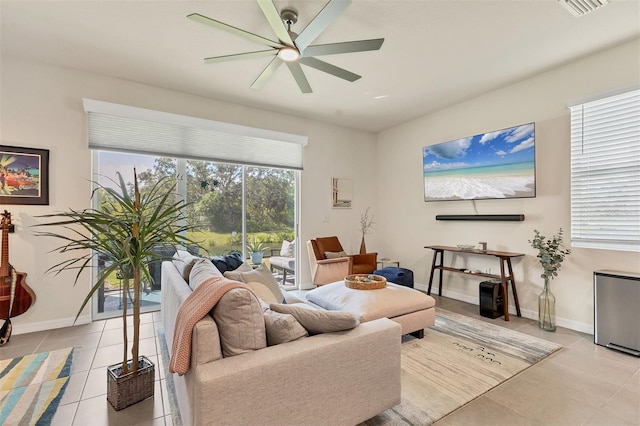 8628 Milestone Dr, Sarasota, FL 34238 - living area with light tile patterned flooring, a ceiling fan, and baseboards