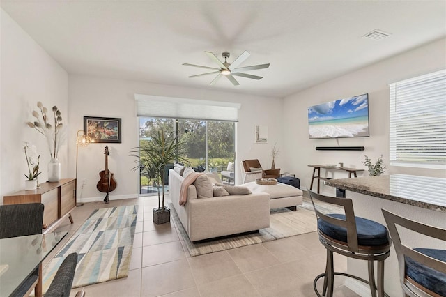 8628 Milestone Dr, Sarasota, FL 34238 - living area featuring a ceiling fan, light tile patterned flooring, and baseboards