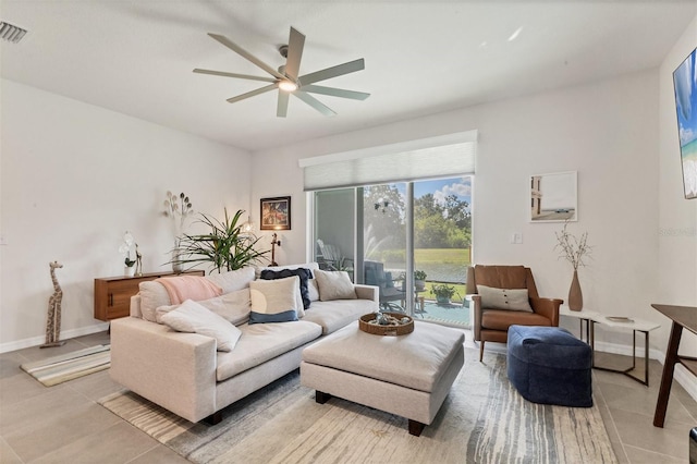 8628 Milestone Dr, Sarasota, FL 34238 - living area featuring a ceiling fan, light tile patterned floors, and baseboards