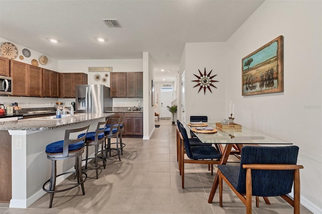 8628 Milestone Dr, Sarasota, FL 34238 - dining space with baseboards, recessed lighting, and light tile patterned flooring