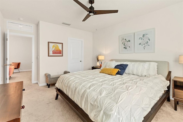 8628 Milestone Dr, Sarasota, FL 34238 - bedroom featuring light carpet, baseboards, and a ceiling fan