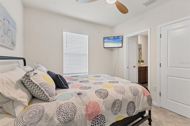 8628 Milestone Dr, Sarasota, FL 34238 - bedroom featuring light colored carpet, ensuite bath, and a ceiling fan