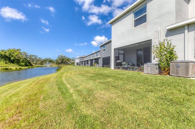 8628 Milestone Dr, Sarasota, FL 34238 - view of grassy yard featuring a water view and central AC