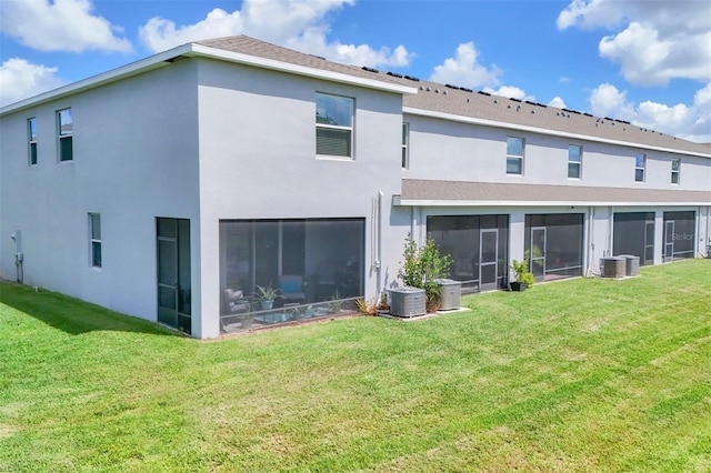 8628 Milestone Dr, Sarasota, FL 34238 - rear view of property featuring a sunroom, stucco siding, and central air condition unit