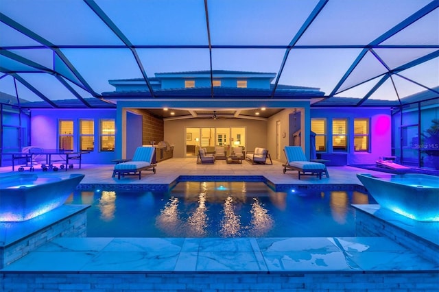 view of swimming pool with an outdoor living space, a patio, and a lanai