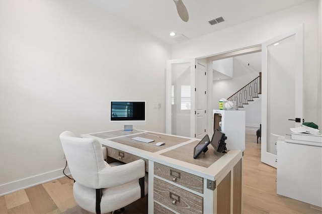 office space with light wood finished floors, baseboards, and a ceiling fan