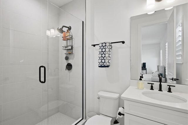 full bath with a shower stall, vanity, toilet, and ensuite bath