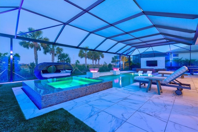 outdoor pool with exterior fireplace, an in-ground hot tub, a patio, and a lanai