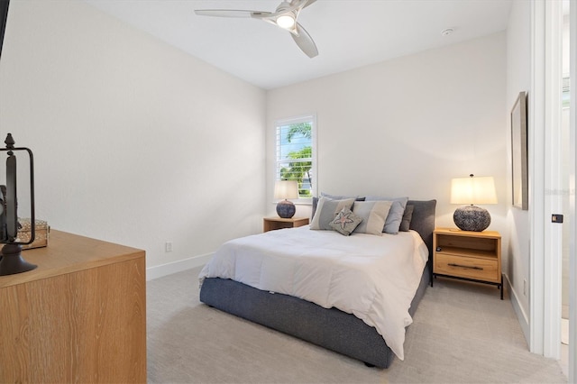 bedroom with light carpet, baseboards, and ceiling fan