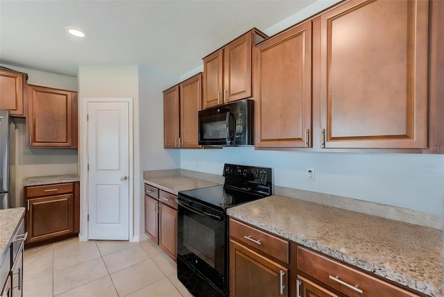 10944 Rainbow Pyrite Dr, Wimauma, FL 33598 - kitchen with black appliances, light tile patterned floors, brown cabinets, and recessed lighting