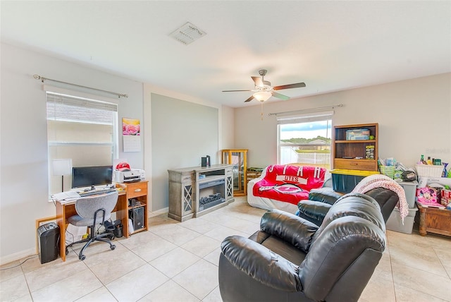 10944 Rainbow Pyrite Dr, Wimauma, FL 33598 - living area with a desk, light tile patterned flooring, a ceiling fan, a fireplace, and baseboards