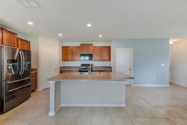 10944 Rainbow Pyrite Dr, Wimauma, FL 33598 - kitchen with black microwave, stainless steel fridge with ice dispenser, a sink, electric stove, and a kitchen island with sink
