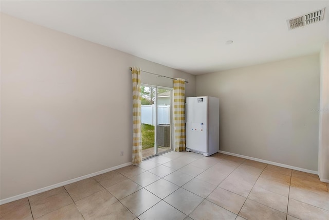 10944 Rainbow Pyrite Dr, Wimauma, FL 33598 - empty room with baseboards and light tile patterned floors