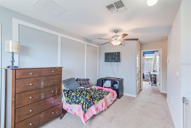 10944 Rainbow Pyrite Dr, Wimauma, FL 33598 - bedroom with light colored carpet, baseboards, a closet, and ceiling fan