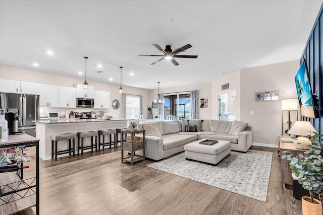 16411 62nd Gln E, Parrish, FL 34219 - living room with ceiling fan, wood finished floors, recessed lighting, and baseboards