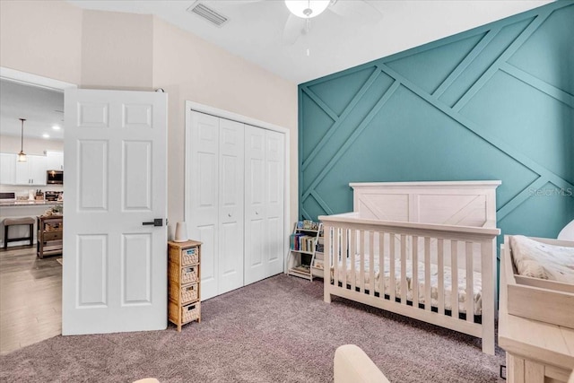 16411 62nd Gln E, Parrish, FL 34219 - bedroom featuring a closet, carpet flooring, a nursery area, and a ceiling fan