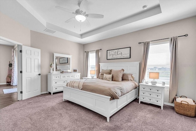 16411 62nd Gln E, Parrish, FL 34219 - bedroom featuring a raised ceiling, carpet floors, ceiling fan, and baseboards