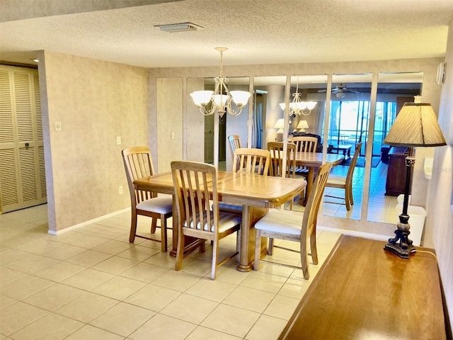 6124 43rd St W Unit 104A, Bradenton, FL 34210 - dining room featuring light tile patterned floors, a chandelier, baseboards, and a textured ceiling