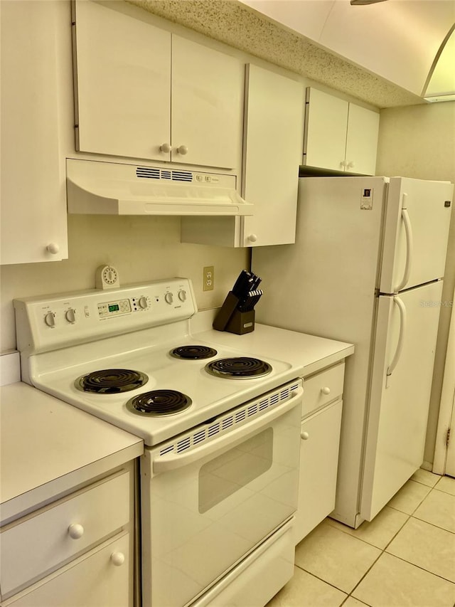 6124 43rd St W Unit 104A, Bradenton, FL 34210 - kitchen featuring white appliances, under cabinet range hood, light countertops, and light tile patterned floors