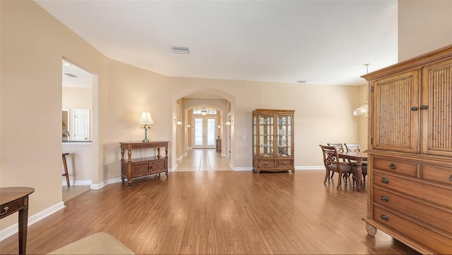 4274 Tennyson Way, Venice, FL 34293 - entryway featuring arched walkways, light wood-style flooring, and baseboards