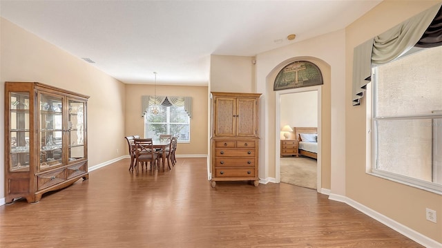 4274 Tennyson Way, Venice, FL 34293 - dining area featuring wood finished floors, a chandelier, and baseboards
