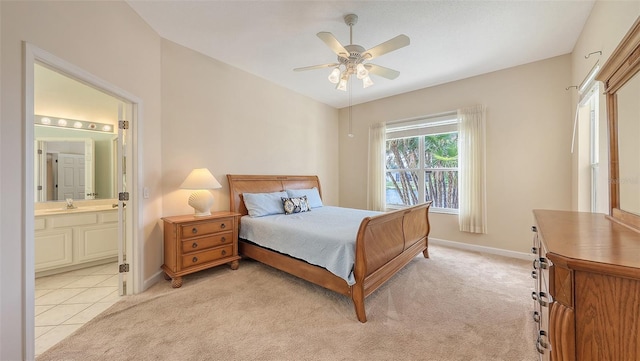 4274 Tennyson Way, Venice, FL 34293 - bedroom with baseboards, ensuite bathroom, light colored carpet, and ceiling fan