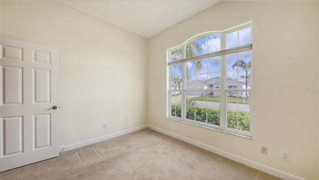 4274 Tennyson Way, Venice, FL 34293 - unfurnished room with baseboards, plenty of natural light, and carpet flooring