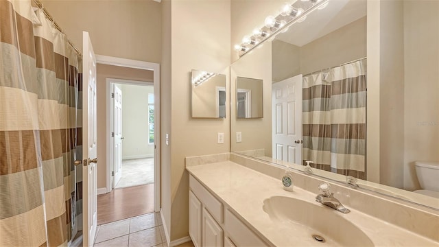 4274 Tennyson Way, Venice, FL 34293 - bathroom featuring tile patterned flooring, toilet, vanity, a shower with shower curtain, and baseboards