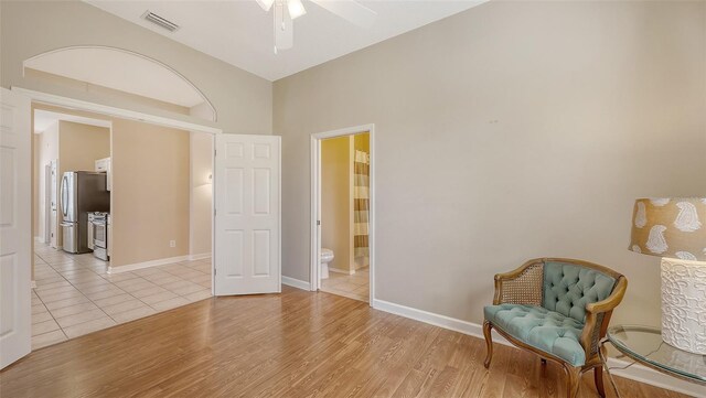 4274 Tennyson Way, Venice, FL 34293 - living area with ceiling fan, light wood-style floors, and baseboards