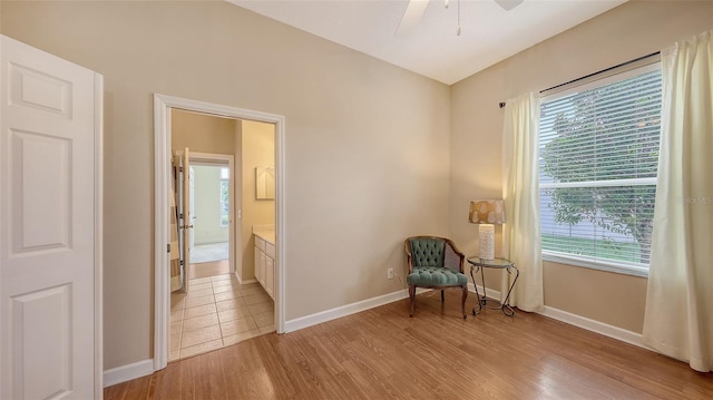 4274 Tennyson Way, Venice, FL 34293 - living area featuring plenty of natural light, a ceiling fan, light wood-style flooring, and baseboards