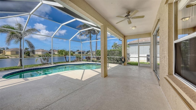 4274 Tennyson Way, Venice, FL 34293 - outdoor pool with a patio, a ceiling fan, a water view, and glass enclosure