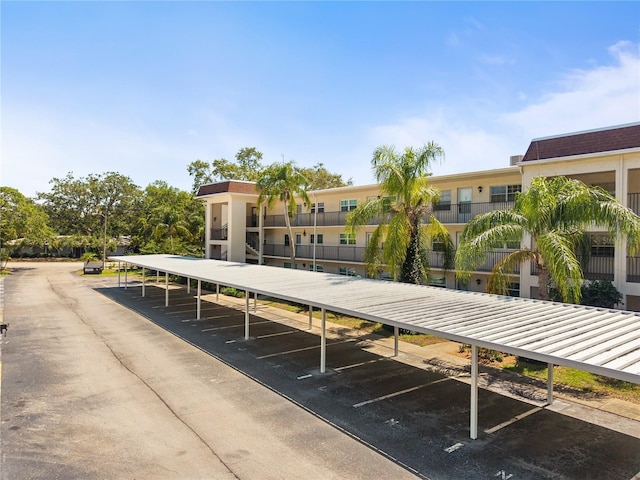 surrounding community featuring covered and uncovered parking