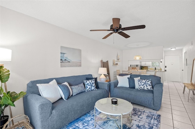 5681 Midnight Pass Rd Unit 104, Sarasota, FL 34242 - living room featuring light tile patterned floors, ceiling fan, and a textured ceiling