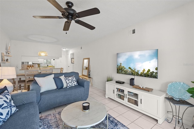 5681 Midnight Pass Rd Unit 104, Sarasota, FL 34242 - living room with light tile patterned flooring, a ceiling fan, and a textured ceiling