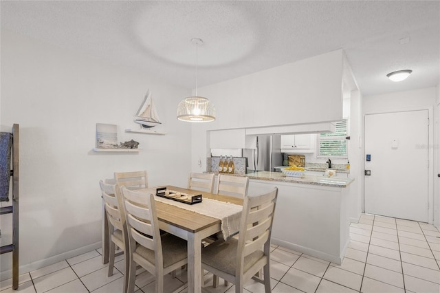 5681 Midnight Pass Rd Unit 104, Sarasota, FL 34242 - dining room featuring light tile patterned flooring and a textured ceiling