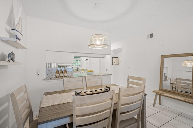 5681 Midnight Pass Rd Unit 104, Sarasota, FL 34242 - dining space featuring light tile patterned floors and a chandelier