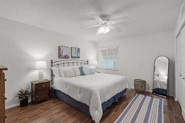 5681 Midnight Pass Rd Unit 104, Sarasota, FL 34242 - bedroom featuring wood finished floors, a textured ceiling, a closet, a ceiling fan, and baseboards