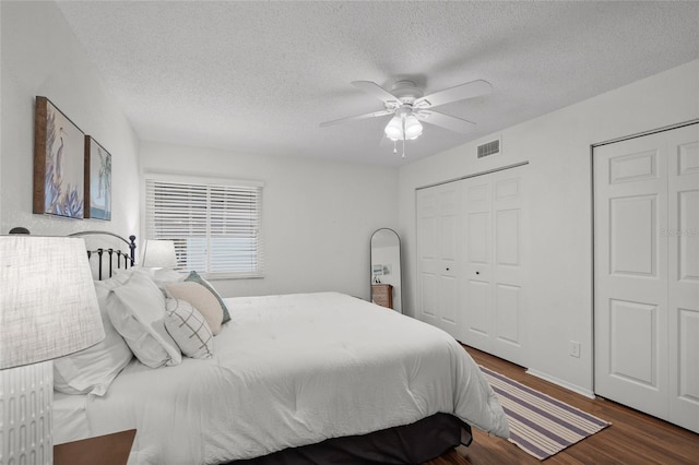 5681 Midnight Pass Rd Unit 104, Sarasota, FL 34242 - bedroom featuring wood finished floors, a textured ceiling, and a ceiling fan