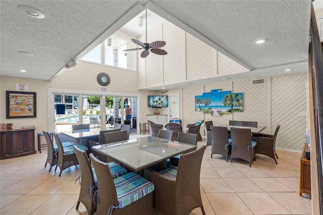 5681 Midnight Pass Rd Unit 104, Sarasota, FL 34242 - dining room with light tile patterned floors, a textured ceiling, a ceiling fan, recessed lighting, and a towering ceiling