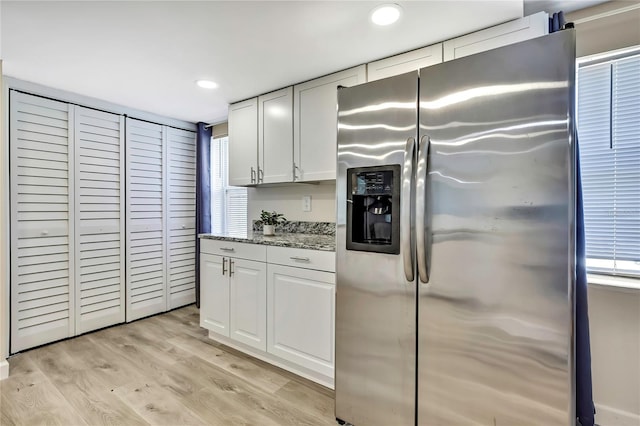 7308 Maryland Ave, Hudson, FL 34667 - kitchen featuring stainless steel fridge, recessed lighting, light stone countertops, white cabinetry, and light wood-style flooring