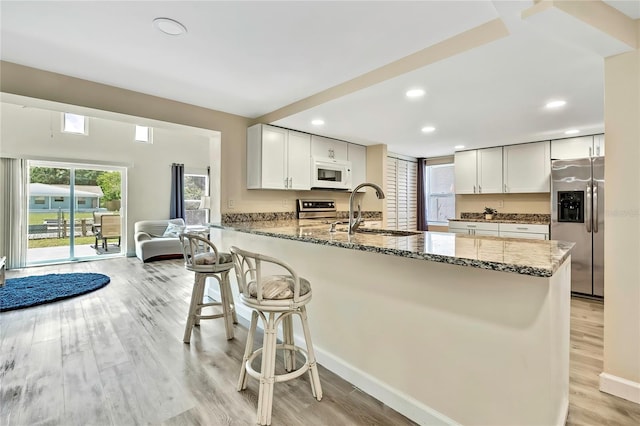 7308 Maryland Ave, Hudson, FL 34667 - kitchen featuring stainless steel appliances, a sink, stone counters, a peninsula, and recessed lighting